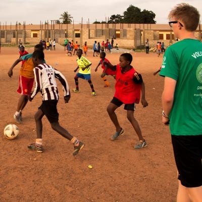 A Projects Abroad volunteer work with teens to teach football in Ghana A sports player gains experience through volunteer football coaching in Ghana